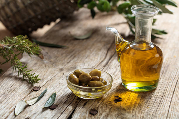 istock Olive oil and olive twig on a table 1042240292
