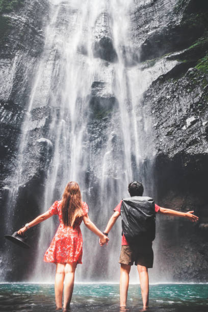 istock Couple standing close to Madakaripura waterfall East Java,IndonesiaIndonesia 1042267528