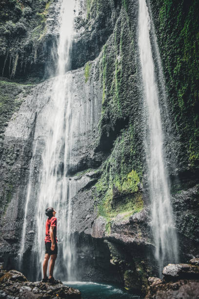 istock Travel Man Adventure and standing relaxation at Madakaripura waterfall East Java,IndonesiaIndonesia 1042267536