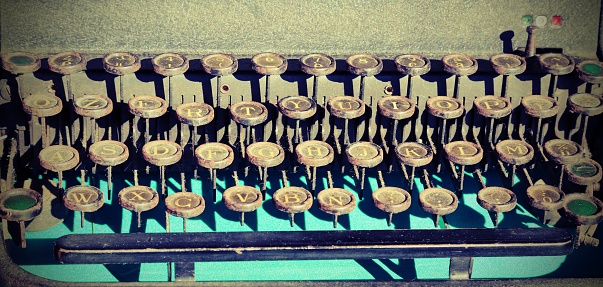 Close up of old adding machine on wooden desk