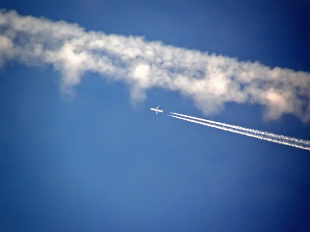 istock Airplane and his vapor stripes on sky 1042276496