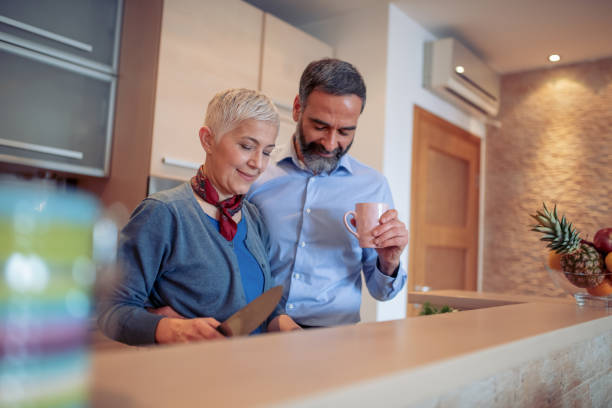 istock Mature couple preparing lunch in kitchen 1042277184