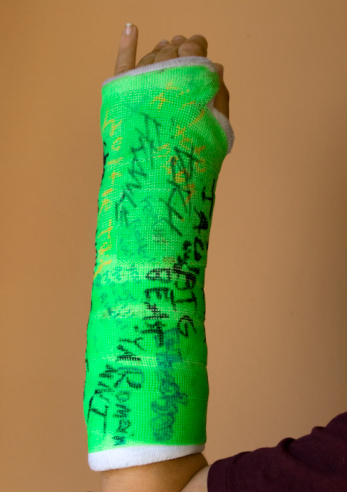 Green Cast with writing on it