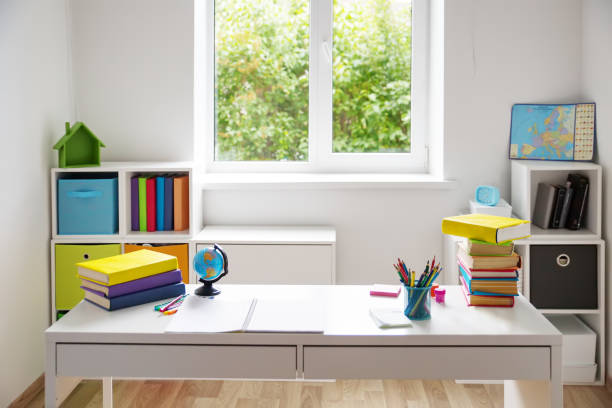 Colourful children rooom with white walls and furniture Colourful children rooom with white walls and furniture. Desk at home interior with a window homework table stock pictures, royalty-free photos & images