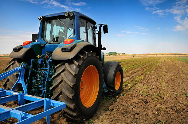 istock Tractor - modern farm equipment in field 104229602