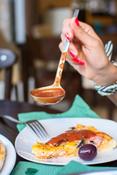 istock putting ketchup on pizza at the restaurant 1042302352