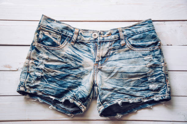 istock Jeans shorts are placed on white wooden floor. 1042305374