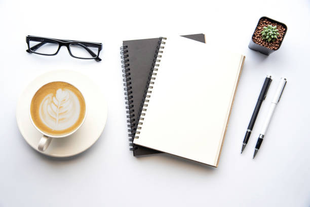 istock Top view with copy space, working desk with laptop,cell phone,notebook pencil and coffee on white background 1042305884