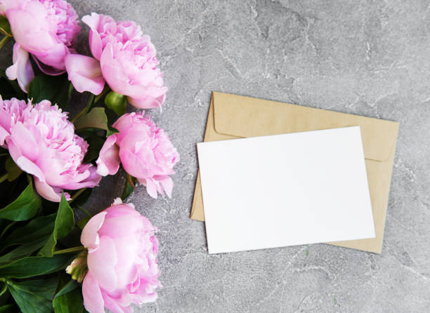 istock invitation card, craft envelope and pink peony flowers 1042306348