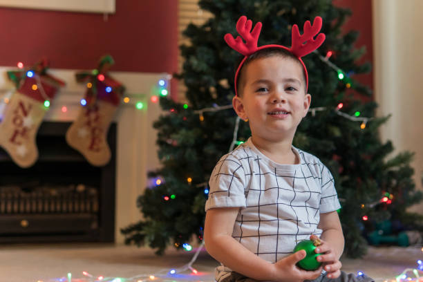 istock Little boy playing with Christmas ornaments 1042311442