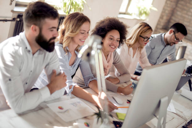 istock Happy group of business people during presentation 1042315302