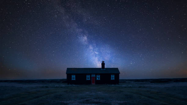 istock Vibrant Milky Way composite image over landscape of Remote desolate isolated house 1042315814