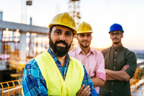 istock Team of engineers on construction site posing and looking at camera 1042316538