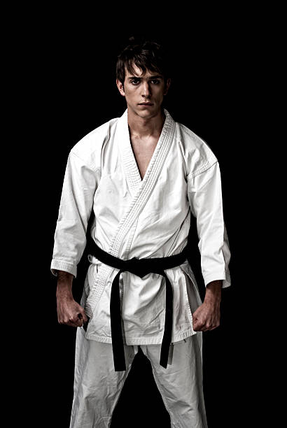 istock High Contrast karate male fighter on black background. 104231768