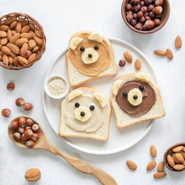 Photo of Nut butter toast in shape of cute funny bear for kids