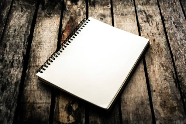 istock White notebooks laying on a wooden table - still life 1042322544