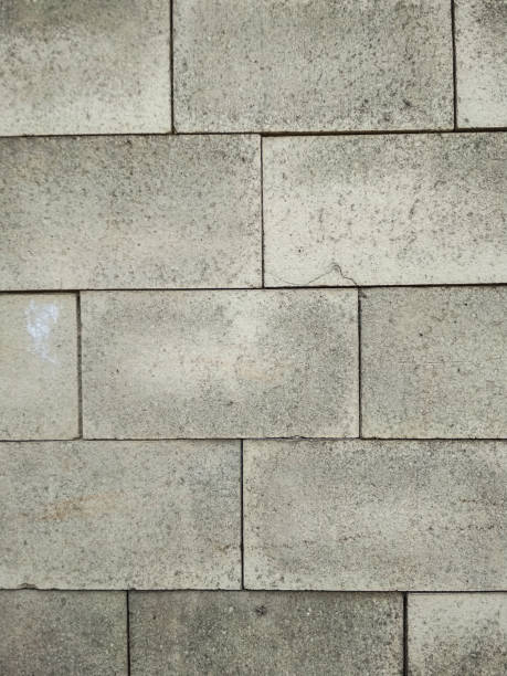 istock Concrete tiles wall texture background. Vertical photo. 1042323244