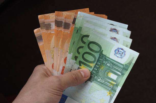 istock Hand with Euro notes, European Union 1042327620
