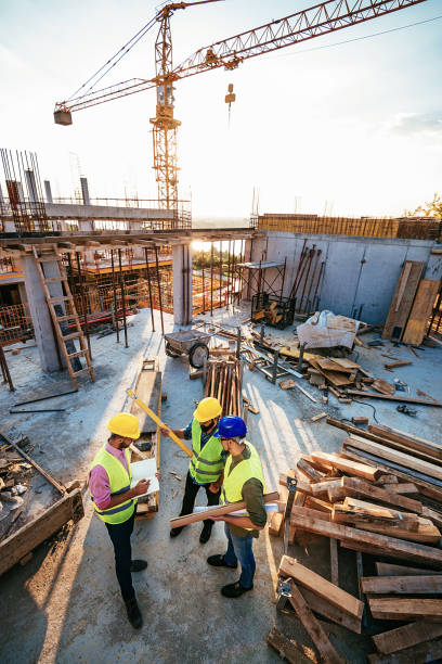 istock Engineers and contractors on the construction site under crane 1042332418
