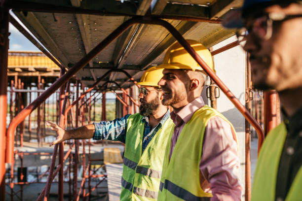 istock Chief engineer talking to architects and contractors under scaffoldings 1042332848