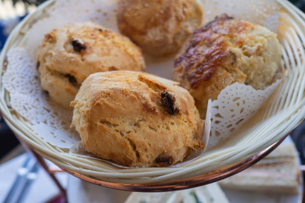 istock Freshly baked scones in a basket at high tea 1042335708