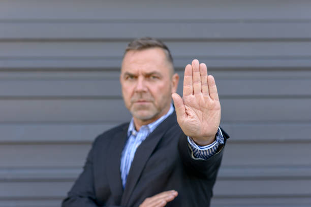 istock Mature man showing stop gesture with hand 1042335906
