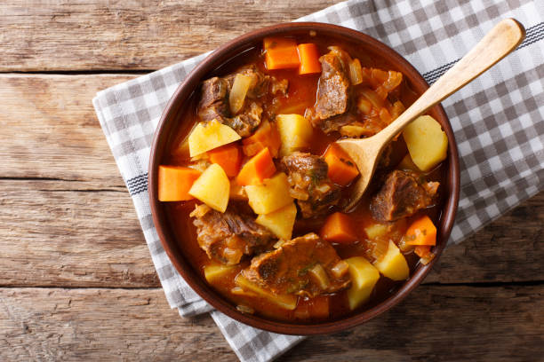 delicious stew estofado with beef and vegetables close-up. Horizontal top view delicious stew estofado with beef and vegetables in a bowl close-up. Horizontal top view from above beef stew stock pictures, royalty-free photos & images