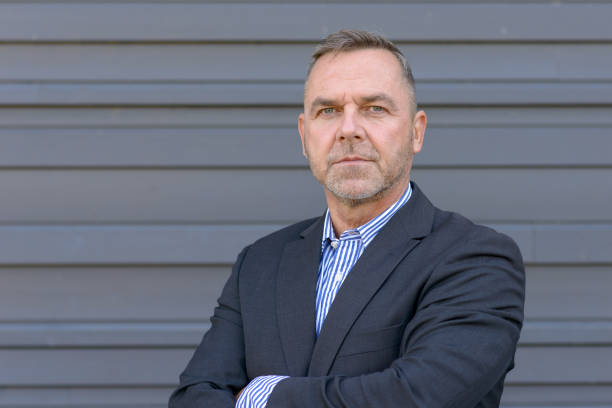 istock Confident middle age businessman over gray 1042346288