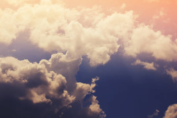 istock Nature background. Fluffy soft clouds in sky toned. 1042350746