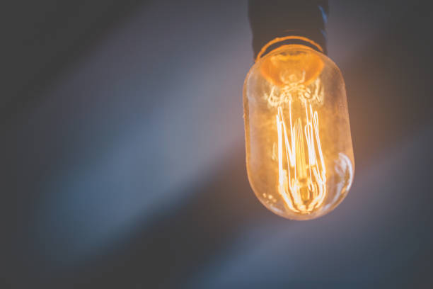 istock Motivation Idea concept - Decorative light bulbs on a dark background, Electric lamp shines. 1042355964