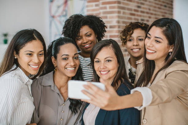 istock Women coworkers making selfie 1042365246