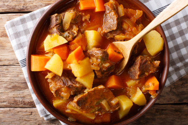 istock Mexican thick estofado soup with beef close-up. Horizontal top view 1042365784