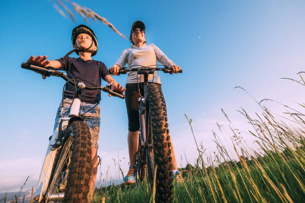 istock Mother with son ride on bycikles together 1042366062