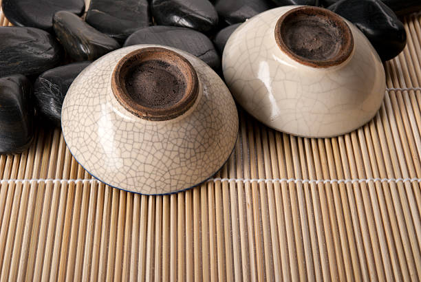 istock Two turned cup for tea lie on stones and mat 104236853