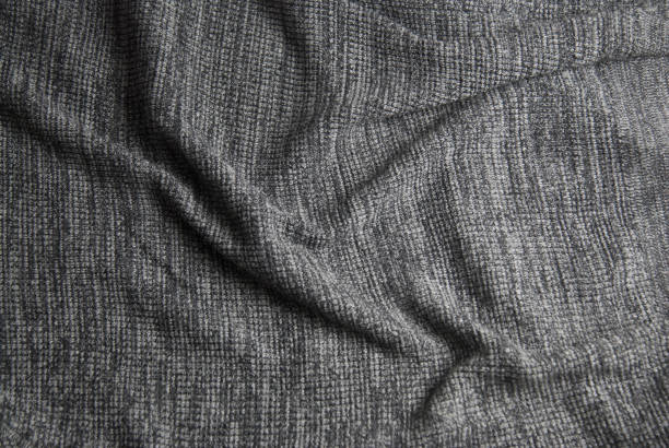 istock Gray knitted blanket. Soft and warm fabric texture. Copy space. Autumn, fall or winter background. 1042368954