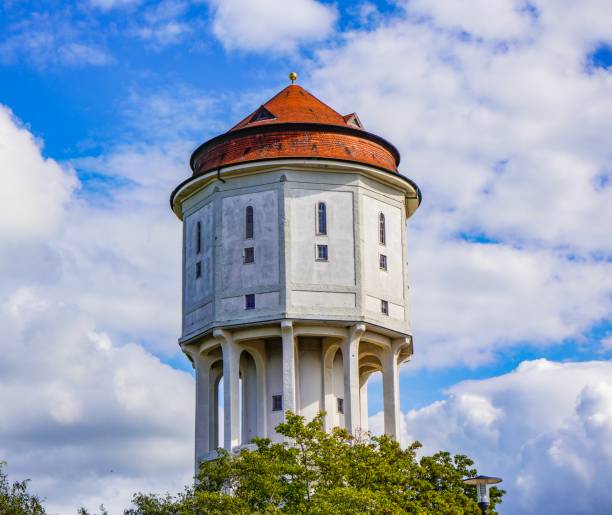 I took a photo of a large housing complex's water tower against the backdrop of a clear blue sky.