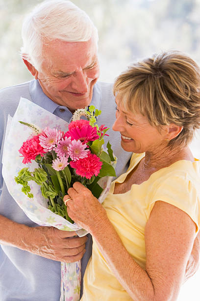 istock Husband giving wife flowers 104237145