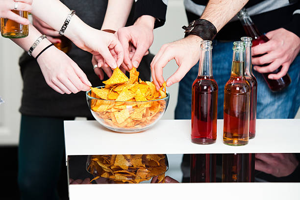 Close up of beer glasses and chips on a bar table at the terrace