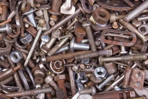 Rusty and dusty bolts and nuts. Chrome bolts and nuts.