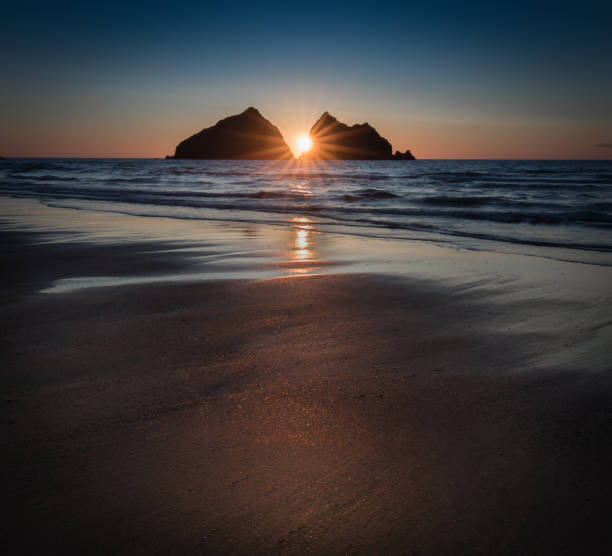 istock Sunstar Sunset reflecting over deserted beach, Holywell Bay, Cornwall 1042380022