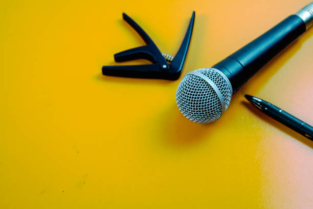 istock The microphone on the table wooden yellow. 1042380332