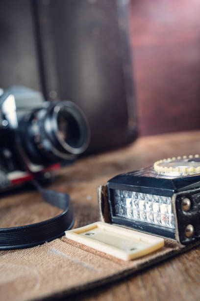 istock Vintage photo camera, light meter and suitcase on table. 1042385400