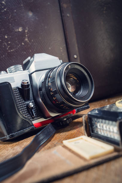 istock Vintage photo camera, light meter and suitcase on table. 1042385498