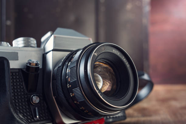 istock Vintage photo camera and suitcase on table. 1042385556