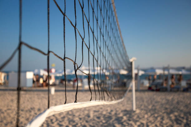 istock beach volleyball net on the seashore on the sunset 1042385972