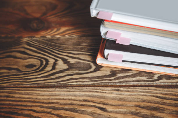 istock Stack of books with bookmarks on a wooden table. Copy space. 1042388188