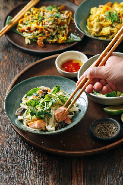 istock Man eating udon noodles with salmon 1042391806