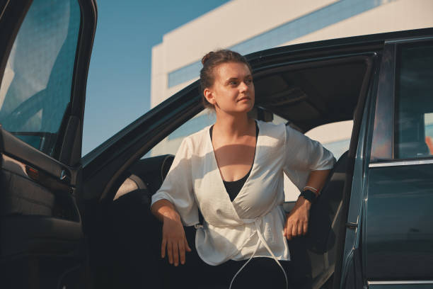 istock Confident woman getting down from car 1042398744