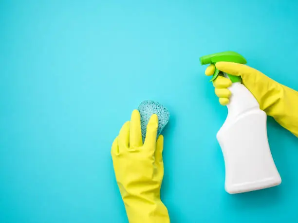 Photo of Detergents and cleaning accessories in pastel color. Cleaning service, small business idea. Top view.