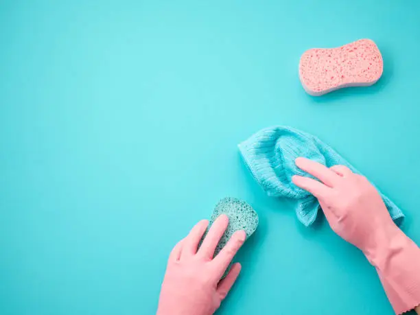 Photo of Detergents and cleaning accessories in pastel color. Cleaning service, small business idea. Top view.